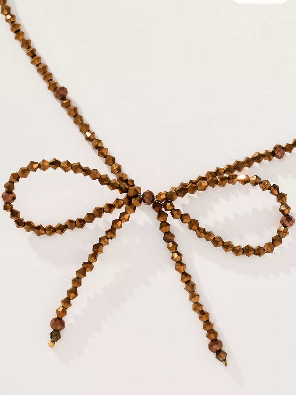 Anthropologie Faceted Beaded Bow Necklace in Bronze